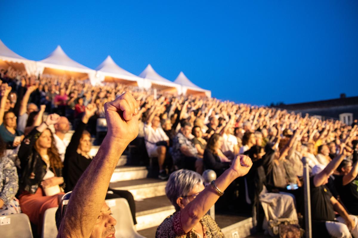 The crowd raised their fists in rhythm with the artists on the big stage at La Corderie.